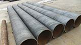 What is the stress state of the spiral steel pipe during the extrusion process
